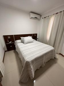 Ένα ή περισσότερα κρεβάτια σε δωμάτιο στο Departamento Villa Carlos Paz Miralejos 3