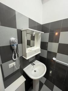 a bathroom with a sink and a mirror at lolly in Paravati