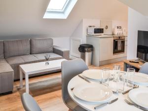 a living room with a table and chairs and a couch at Hanoverian Suite - Uk41830 in Tickton