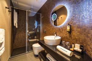 a bathroom with a sink and a toilet and a mirror at Lux Housing Século XXI in Braga +56 photos
