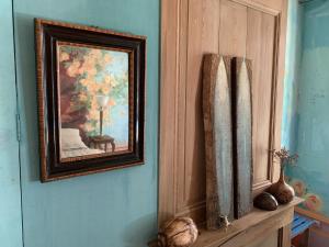 a painting of a vase on a blue wall at Purple House in Saint-Valery-sur-Somme