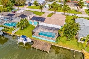 an aerial view of a house with a boat on the water at Brayden-Wes Beach House in Cocoa Beach