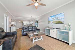 a living room with a leather couch and a table at Windemere 1003 in Perdido Key