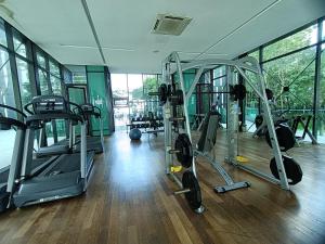 a gym with several tread machines in a room at Pax 6+3 Grand Lux Melaka homestay in Melaka