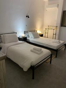 dwa łóżka siedzące obok siebie w pokoju w obiekcie Mani Spot w mieście Areopolis