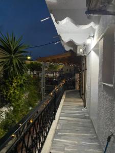 a balcony of a building with lights on it at Mani Spot in Areopolis