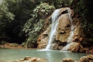 a waterfall in the middle of a pool of water at 3 Bedroom Pool Villa 50M To The Beach in Las Terrenas