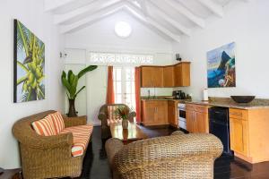 a kitchen with two chairs and a table at Fond Doux Eco Resort in Soufrière