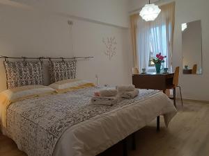 a bedroom with a large bed with two towels on it at Il Torrione in Guardiagrele