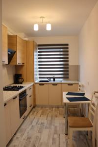 a kitchen with a sink and a stove top oven at All Homes by Nati in Braşov +178 photos