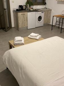 a bedroom with a white bed and a washing machine at Mani Spot in Areopoli +46 photos