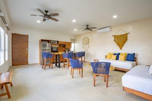 a living room with a couch and a table and chairs at Casa Elda in Tulum