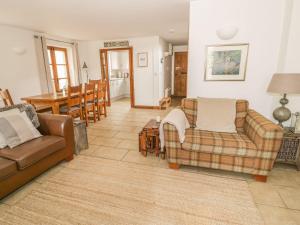 a living room with two couches and a table at Bridge House in Cirencester