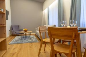 a living room with a table and chairs and a dining room at Luxury Apartments Anja in Jahorina