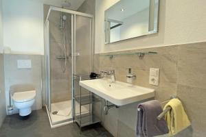 a bathroom with a sink and a shower and a toilet at Apart - und Frühstückspension Jägerheim in Kaunertal +75 photos