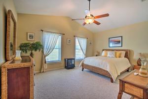 a bedroom with a bed and a ceiling fan at Oceanfront Oasis in Cedar Key with 2 Balconies! in Cedar Key