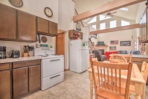 een keuken en een woonkamer met een witte koelkast bij Twin Lakes Home - Walk to Lake Elizabeth! in Twin Lakes