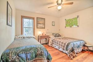 a bedroom with two beds and a ceiling fan at Twin Lakes Home - Walk to Lake Elizabeth! in Twin Lakes