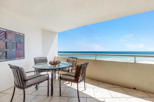 a dining room with a table and chairs and the ocean at Perdido Sun 612 in Perdido Key