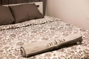 a bed with a wooden foot board on it at Beautiful Apartment - Ben Yehuda - City Center in Jerusalem