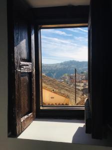 an open window with a view of a city at El Ventanillo in Toledo