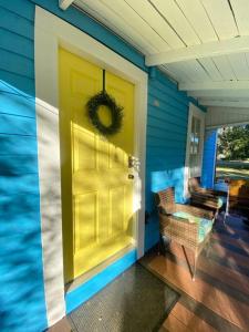 a yellow door on the front of a house at The Mellow Yellow in Sanford