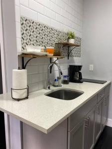 a kitchen with a sink and a counter top at The Mellow Yellow in Sanford
