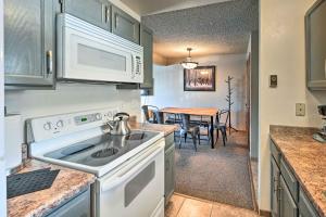 a kitchen with a sink and a stove top oven at Mtn-View Condo about 3 Mi to Dtwn Steamboat Springs! in Steamboat Springs