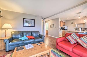 a living room with a couch and a table at Portage Lake Condo with Deck and Pool Access! in Onekama