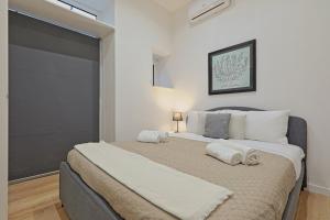 a bedroom with a large bed with two towels on it at Costantino 11 Central Welcoming APT x4 in Palermo
