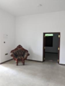 a chair sitting in the middle of a room at Mango Tree Weligama in Weligama