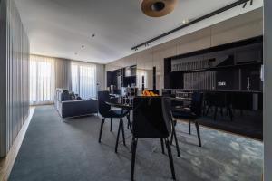 a living room with a dining table and chairs at Lux Housing Século XXI in Braga