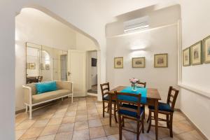 a dining room with a table and chairs and a couch at Terme Apartment in Florence