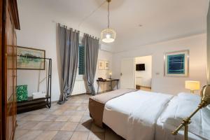 a bedroom with a large white bed in a room at Terme Apartment in Florence