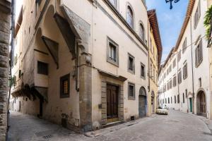 an alley in an old town with a car parked on the street at Terme Apartment in Florence