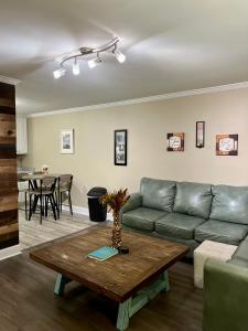 a living room with a couch and a table at Trinity One Apartments - Country Luxury in Jackson