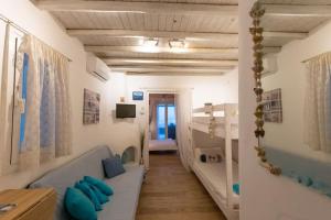 a hallway of a room with a couch and a table at Seafarer's House. Ideal for 3+1 guests in Mikonos
