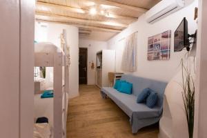 a room with a bunk bed and a couch at Seafarer's House. Ideal for 3+1 guests in Mikonos
