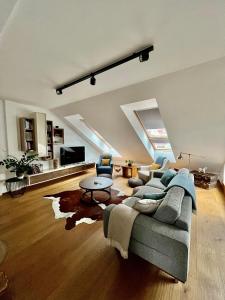 a living room with a couch and a table at The Luxury Penthouse in Banská Bystrica