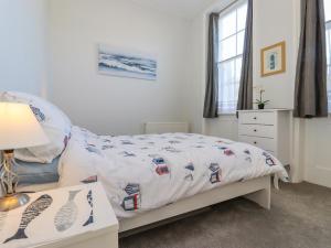 a bedroom with a bed with a comforter on it at The Old Spy Headquarters in Folkestone