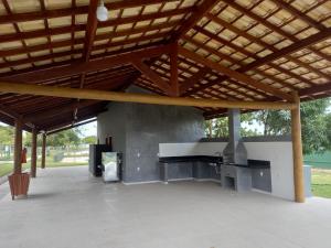 a large pavilion with a piano under a wooden roof at Na Casa da Anna in Porto Seguro