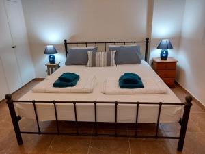 a large bed with two pillows on it in a bedroom at Queens Gardens suite by the sea, pool and mall in Nea Paphos +21 photos