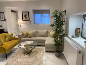 a living room with a couch and a table at Elegant 2 Bed Flat in Chiswick in London