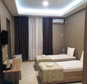 Uma cama ou camas num quarto em Vita Gardenia Hotel Tskaltubo