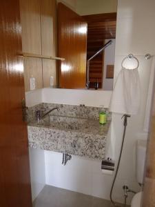 a bathroom with a sink and a toilet at Sítio Passo do Carro in São Francisco de Paula