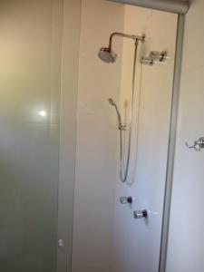 a shower in a bathroom with a glass door at Sítio Passo do Carro in São Francisco de Paula