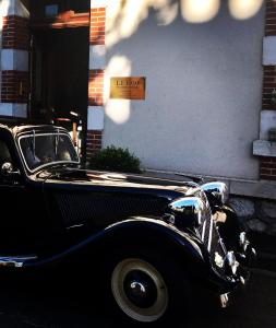 an old black car parked in front of a building at Le 1930, chambres d’hôtes de charme in Cosne Cours sur Loire +47 photos