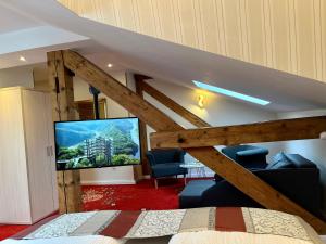 a bedroom with a loft bed with a flat screen tv at Hotel Stadtvilla Laux in Merzig