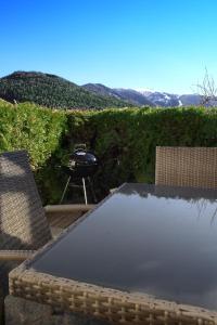 a grill sitting on top of a table with chairs at Landhaus Anita Dolomiten Kronplatz in Perca