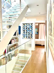 a glass staircase in a house with bookshelves at Catany - Casa familiar in Palma de Mallorca
